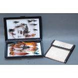 Fly box containing salmon flies and fly wallet containing trout flies.