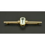 An Edwardian 15 ct gold bar brooch, set with diamonds totalling .25 carats and 5 carat aquamarine.
