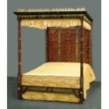 A four poster bed, with gilt painted moulded wooden cornice,