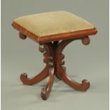 A Victorian square mahogany footstool, raised on four downswept legs terminating in scroll feet.