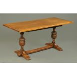 A reproduction oak refectory table, with bulbous supports and low centre stretcher,
