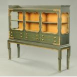 A 1930's green and gilt painted German display cabinet,