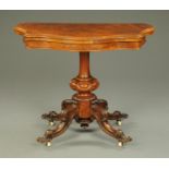 A Victorian walnut turnover top games table, of serpentine outline,