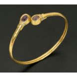 A 9 ct gold bracelet, set with amethyst coloured stones.