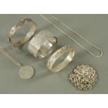Three silver bangles, and various chains.