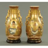 A pair of Japanese Satsuma vases, decorated with faces, red seal mark to base,