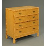 A rattan chest of four drawers, with brass drop handles and with bamboo feet. Width 93 cm.