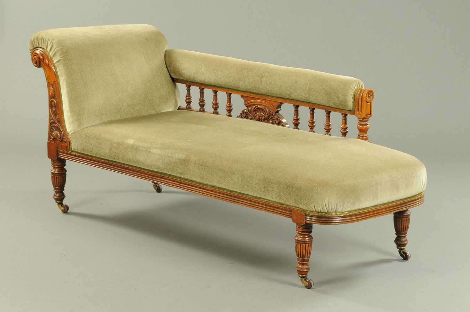 A late Victorian oak framed chaise longue,