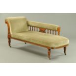 A late Victorian oak framed chaise longue,