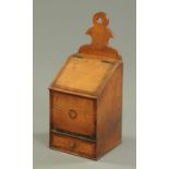 A George III oak and mahogany crossbanded candle box, with slope front and drawer. Height 42 cm.