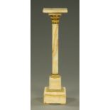 An Edwardian marble column, with swivel top, brass mounts and square stepped base.