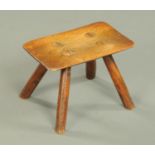 A 19th century small Treen footstool, with four angled legs. Width 23 cm.