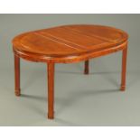 A Chinese hardwood dining table, with two leaves, circular when closed,