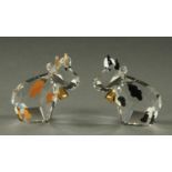 A pair of Swarovski crystal miniature cows, in cylindrical cardboard case (see illustration).