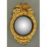 A Regency gilt framed mirror, with convex glass and eagle mount.