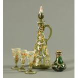 An enamelled green glass decanter, with three glasses, and a silver mounted scent bottle.