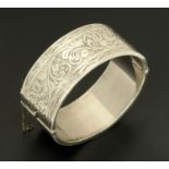 An engraved Edwardian silver hinged bangle, Birmingham 1913/14.