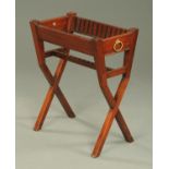 A 19th century mahogany plate stand, to hold twelve plates, with carrying handle to either side.