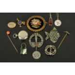 A collection of Scottish brooches, stick pins, amber pendant, silver padlock, etc.