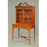 An Edwardian inlaid mahogany cabinet/desk, with swans neck pediment, pair of glazed doors,