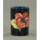 A Moorcroft Hibiscus cylindrical pin pot, impressed "Moorcroft, Made in England". Height 6.5 cm.