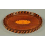 A 19th century inlaid mahogany oval waiter. Length 30 cm.