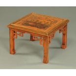 A Chinoiserie red and gilt lacquered coffee table, with glass top,