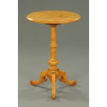 A Victorian maple tripod table, with circular top, turned column and three downswept legs.