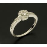 An 18 ct white gold diamond cluster ring, with diamond set shoulder, size M/N.