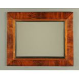 A mahogany framed wall mirror, with ebonised slip. Exterior dimensions 67 cm x 55 cm.