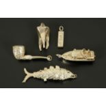 Five large silver charms, fish, pipe, tooth, boat, ingot. Longest 65 mm.