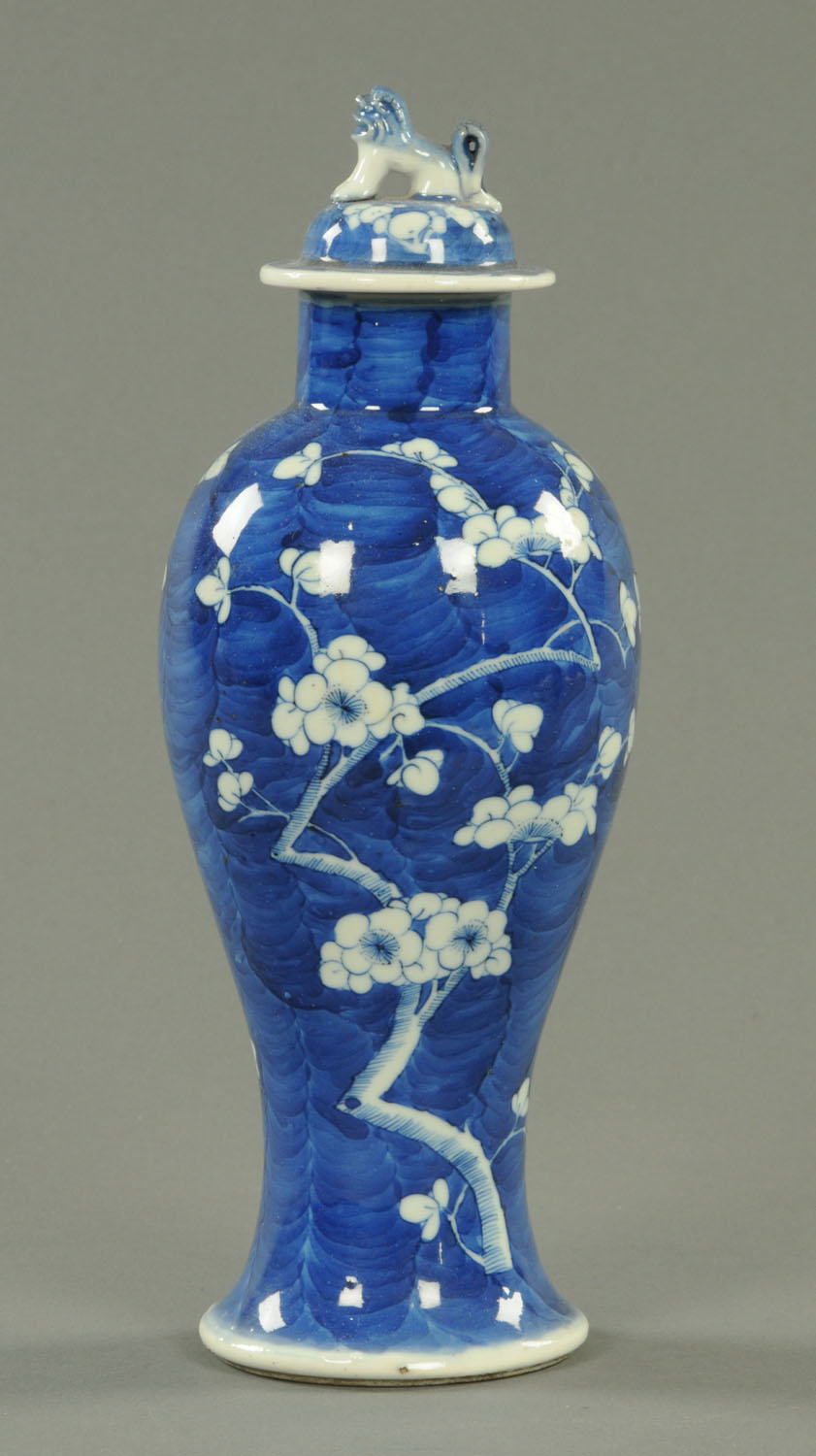 A 19th century Chinese Prunus lidded vase, with dog terminal, four character mark to base.