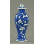 A 19th century Chinese Prunus lidded vase, with dog terminal, four character mark to base.