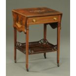 An Edwardian rosewood twin drop flap occasional table, with frieze drawer and low shelf.