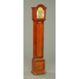 A mahogany grandmother clock, circa 1931, with three-train movement. Height 170 cm.