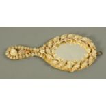 A Victorian sailor work shell encrusted hand held mirror. Height 26 cm.