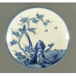 A 19th century blue and white Imari charger, decorated with birds and branches,