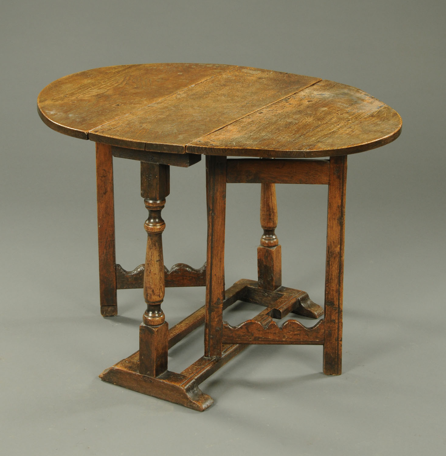 An 18th century oak gate leg table, twin drop flap. Width 81 cm, length open 97 cm.