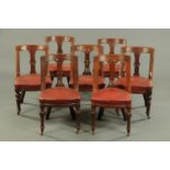 A matched set of seven Victorian mahogany dining chairs, each with incised bowed top rail,