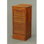 An Edwardian oak shutter front filing cabinet, with rear upstand and plinth base. Width 48 cm.