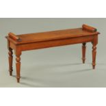 A Regency style mahogany window seat, with bolster ends and turned legs. Length 105 cm.