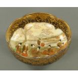 A Japanese Meiji period bowl, figural, heightened with gilding, character marks to base.