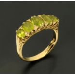 A 9 ct gold ring, set with five peridot, size R.
