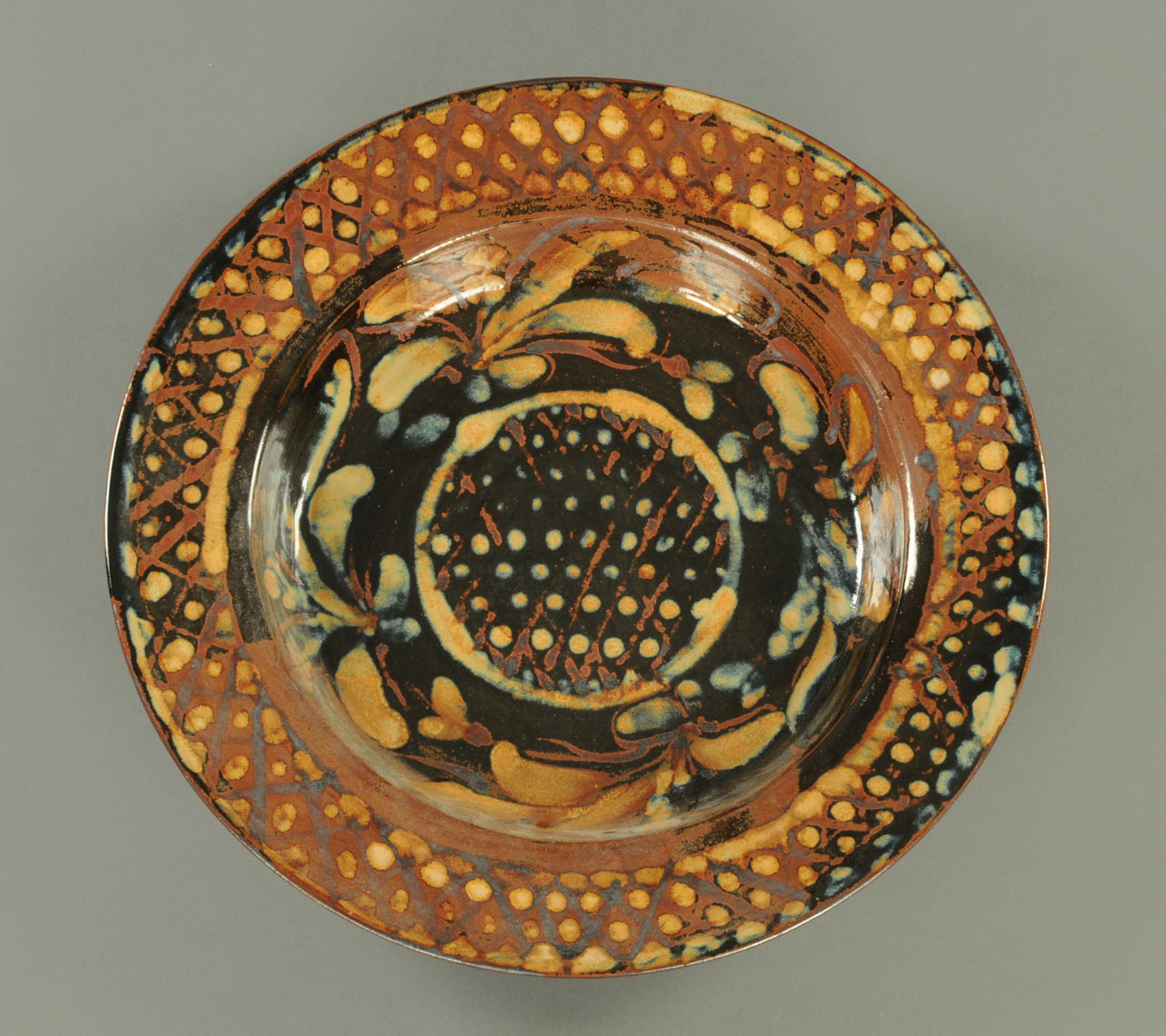 A Studio Pottery plaque, incised "S.P. Drymen". Diameter 47.5 cm (see illustration).