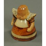 A Royal Doulton Suffragette figure, in the form of a baby, impressed marks to base.