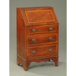 An Edwardian inlaid mahogany bureau, with slope front to fitted interior,