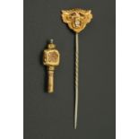 A gold coloured stick pin, lion mask form, set with a diamond, 1.