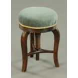 A Victorian mahogany circular stool, with stuffover top and swivel action.