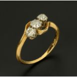 An 18 ct gold three stone diamond ring, size Q/R.