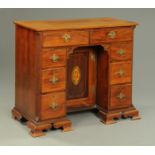 A George III mahogany kneehole desk, boxwood and ebony strung, with two frieze drawers,